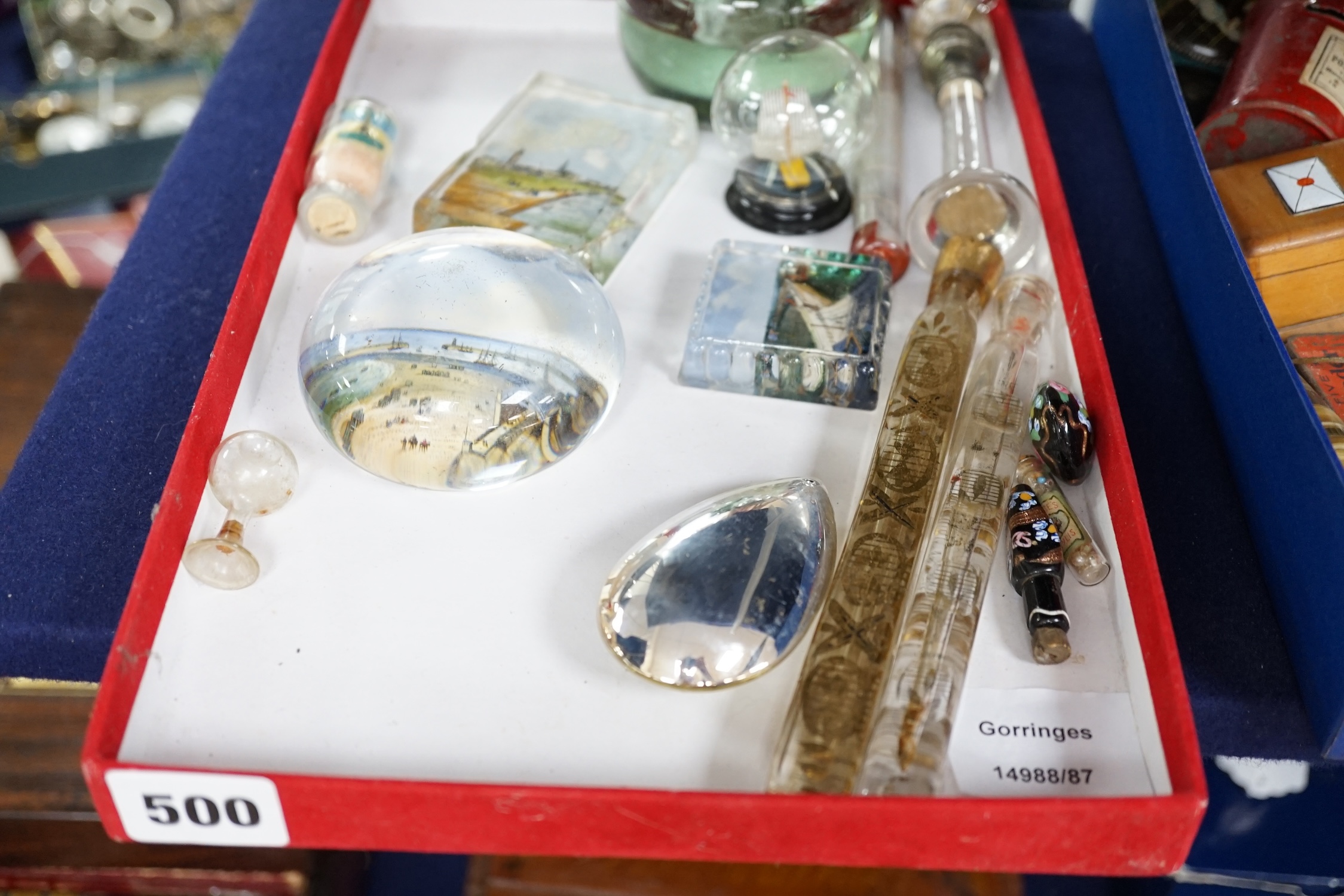 A collection of mixed Victorian glass perfume bottles and files, souvenir paperweights, a glass letter opener and vase, etc. Condition - fair